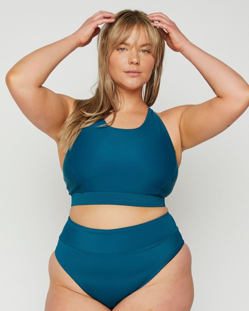 Front of a model wearing a size 10|12 Capri High Tide Cheeky Bottoms in Amalfi Blue by Wild Isles Swim. | dia_product_style_image_id:284895